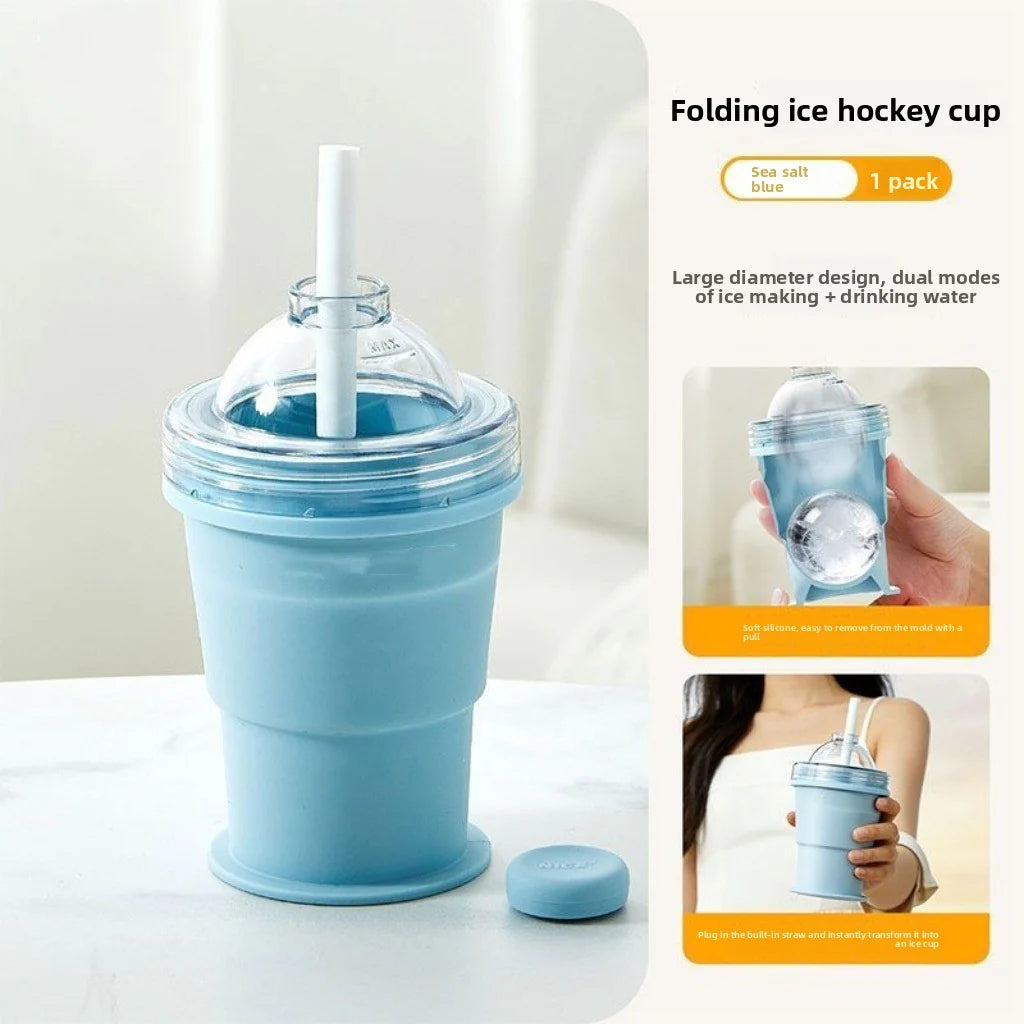 Blue collapsible silicone cup with clear lid, straw, and flat silicone base