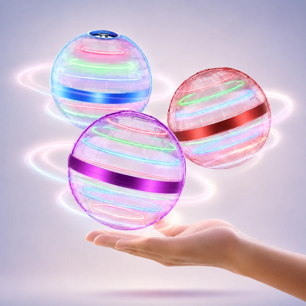 Three-globe LED flying orb drone set in pastel colors, held above an open hand