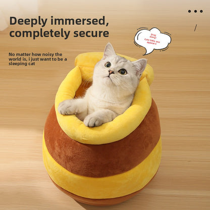 Cat nest bed with rounded donut shape and plush yellow cushion, cat resting inside