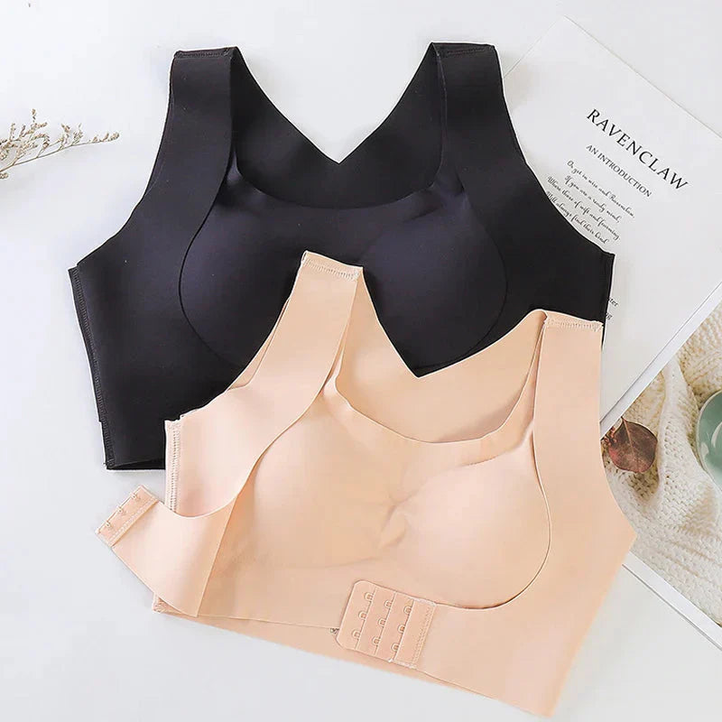 Posture-correcting bras, black and beige, with hook-and-eye back closure.