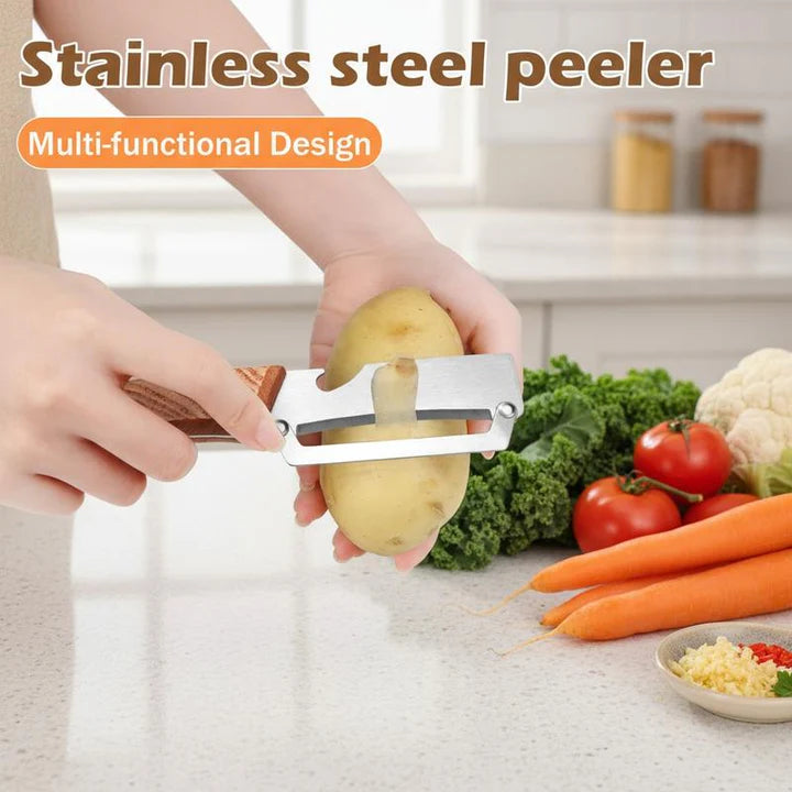 Stainless-steel vegetable peeler with wooden handle peeling a potato