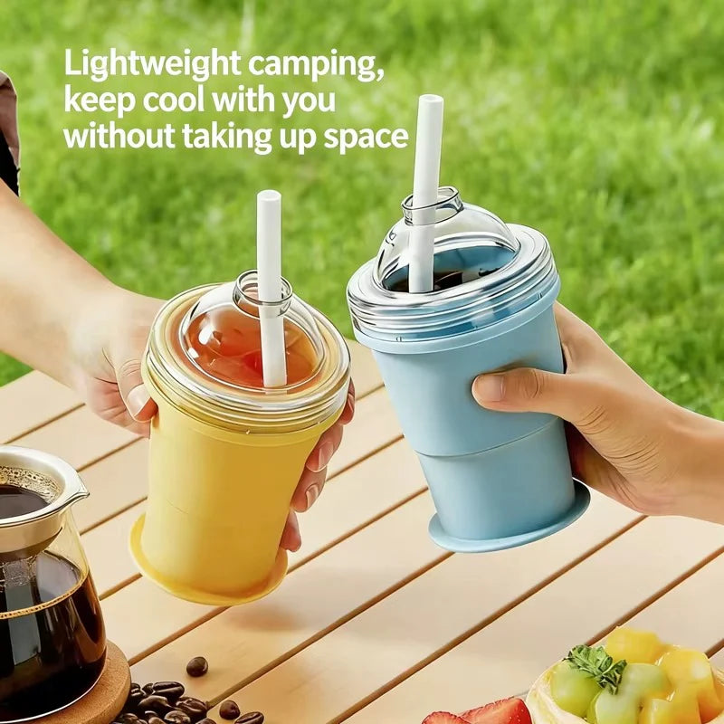 Two collapsible ice cups, blue and yellow, with clear tops and drinking straws
