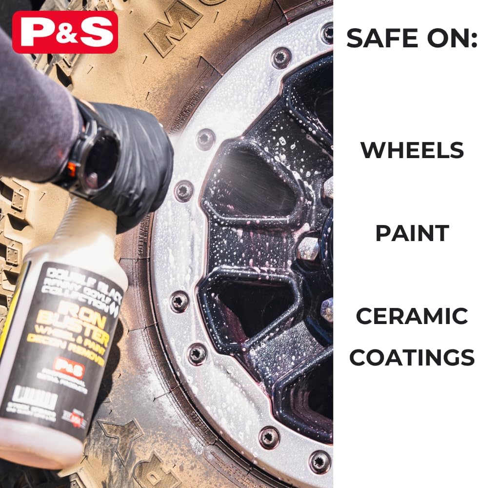 Iron remover bottle spraying a wheel rim with foamy white residue