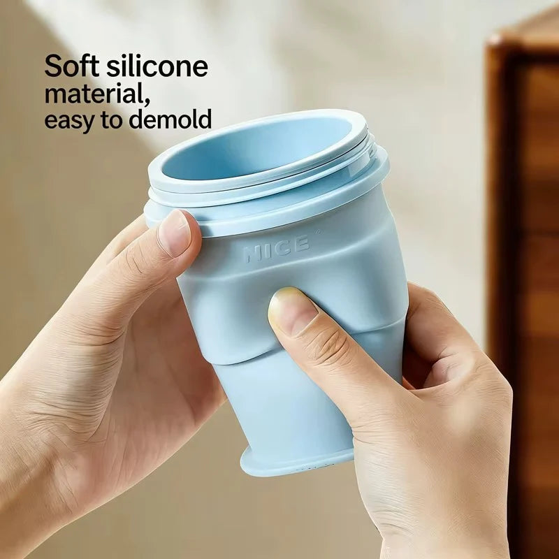 Light-blue collapsible silicone ice cup folded, shown by hands