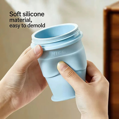 Light-blue collapsible silicone ice cup folded, shown by hands