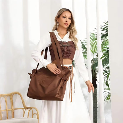 Brown foldable travel organizer bag with shoulder straps and front flap pocket